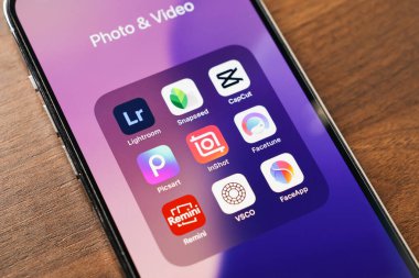 Poznan, Polonya - 12 Mart 2025: Deniz feneri, snapseed, capcut, facetune, picsart, inshot, remini, vsco ve faceapp gibi popüler fotoğraf ve video kurgu uygulamaları içeren akıllı telefon ekranı 