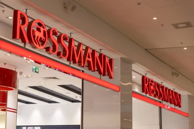 Poznan, Polonya - 22 Mart 2025: Rossmann mağaza önü, alışveriş merkezinin içinde parlak kırmızı ışıklı logo ve modern iç tasarımla tanınabilir eczane ve güzellik perakende zinciri sergileniyor