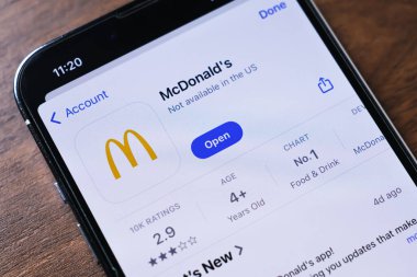 Poznan, Polonya - 26 Mart 2025: Fast food siparişleri vermek, menü ögelerine bakmak, özel tekliflere ulaşmak için tasarlanmış McDonalds uygulamasını gösteren bir akıllı telefonun yakın çekimi. 