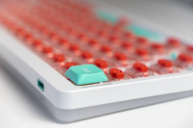 Açığa çıkan kırmızı düğmeler arasında bir deniz mavisi ESC anahtarının yer aldığı mekanik bir klavyenin makro görüntüsü, dokunsal tepki ve estetik özelleştirmeye odaklanmış kişiselleştirilmiş bir ayarın gösterilmesi