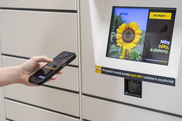 Poznan, Poland - May 2, 2025: A person is using a smartphone with an InPost application open, ready to scan a code at a self-service parcel locker