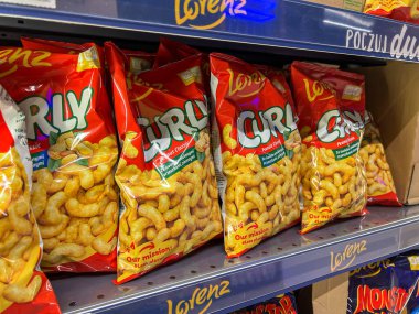 Poznan, Polonya - 23 Nisan 2025: Lorenz Kıvırcık Fıstık Klasik abur cubur paketleri perakende rafında tanımlayıcı Lehçe metin, mağazada satılık ürün