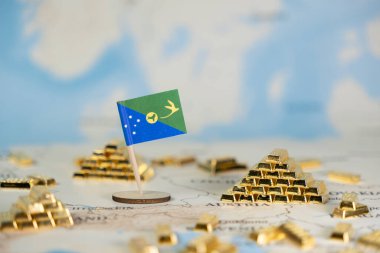 Ulusal zenginlik, küresel finans ve kaynak yönetimini gösteren minyatür bir Noel Adası bayrağı dünya haritası boyunca yayılmış birçok altın külçeler arasında yer almaktadır.