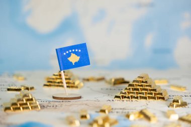 Kosova 'nın minyatür bayrağı ve parıldayan altın külçeleri bir dünya haritasında ulusal ekonomik büyüme, refah ve geniş kopya alanına sahip küresel yatırımı sembolize ediyor