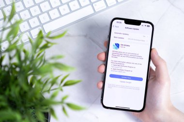 Poznan, Polonya - 10 Haziran 2025: Yeni iOS 26 Beta yazılım güncellemesini gösteren, yenilikçi Sıvı Cam teknolojisi ve geleceğin gelişigüzel el ele tutuşunun ayrıntıları