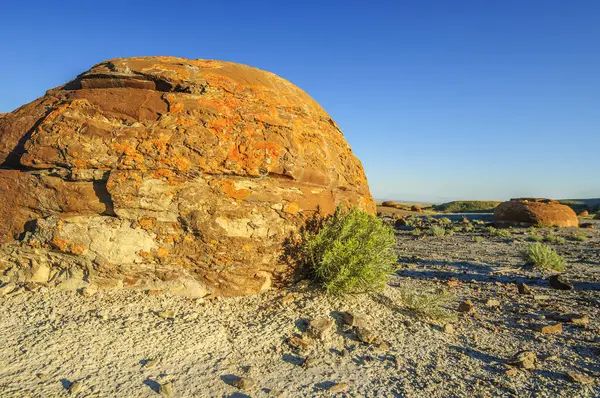 Stock image A spherical sandstone concretion stained red by iron oxide, in the Red Rock Coulee Natural area in southern Alberta