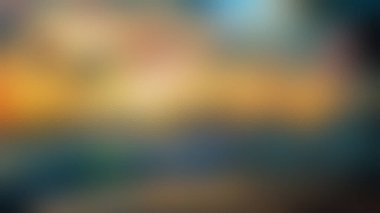 Ilık altın renkler ve serin, koyu mavi ve yeşilliklerin karışımından oluşan soyut, odaksız bir görüntü..