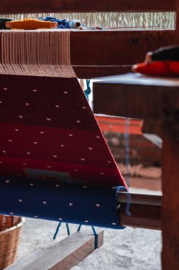 A stunning display of a variety of traditional Teotitlan carpets stacked neatly in Oaxaca clipart