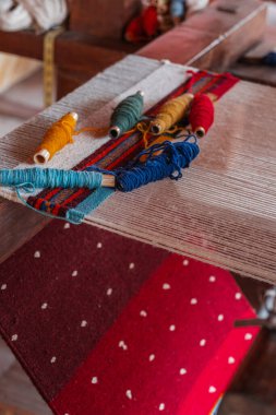 A stunning display of a variety of traditional Teotitlan carpets stacked neatly in Oaxaca clipart