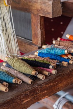 A stunning display of a variety of traditional Teotitlan carpets stacked neatly in Oaxaca clipart