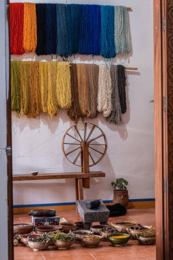 A stunning display of a variety of traditional Teotitlan carpets stacked neatly in Oaxaca clipart