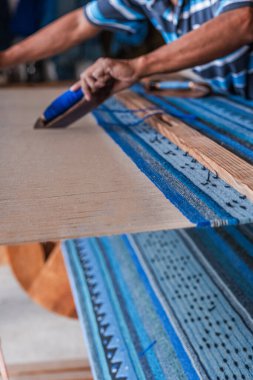 A closeup of the intricate process of making artisanal rugs or tapetes in Teotitlan Oaxaca clipart