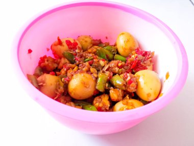 a bowl of balado quail eggs and tempeh ready to eat isolate on white clipart