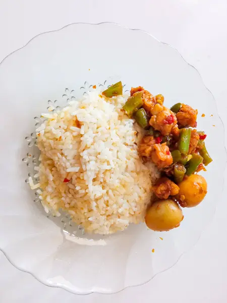 stock image a plate of rice with a side dish of quail eggs ready to eat isolate on white