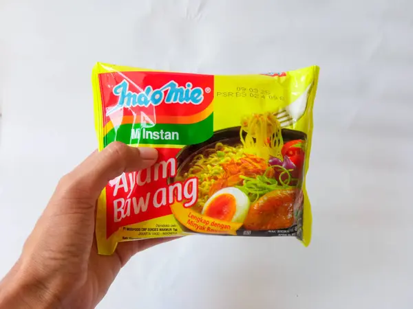 stock image Surabaya, Indonesia - August 8 2024. Indomie Kuah. Famous indonesian instant noodle brand with ayam bawang (chicken onion flavor) isolated on clean white background.