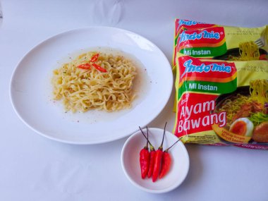 Surabaya, Indonesia - August 8 2024. Indomie Kuah. Famous indonesian instant noodle brand with ayam bawang (chicken onion flavor) isolated on clean white background. clipart