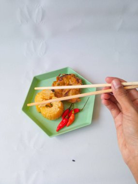 Gorengan : Fried food is one of the most popular types of snacks in Indonesia. Indonesian street food.Black background. clipart