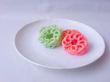 Beyaz tabaktaki renkli krakerler izole edilmiş.