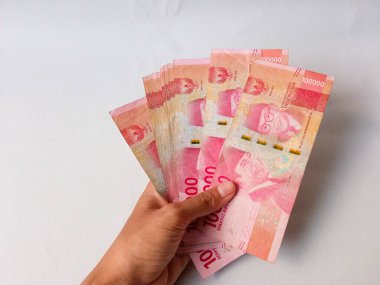 Cash payment concept. Indonesian rupiah currency (Rp. 100.000 Seratus Ribu Rupiah), One hundred thousand Indonesian rupiah money.