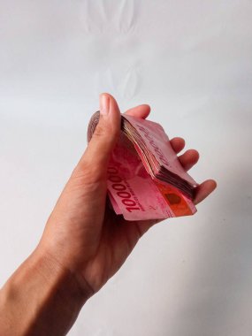 Cash payment concept. Indonesian rupiah currency (Rp. 100.000 Seratus Ribu Rupiah), One hundred thousand Indonesian rupiah money.