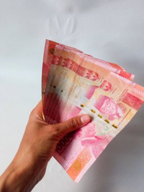 Cash payment concept. Indonesian rupiah currency (Rp. 100.000 Seratus Ribu Rupiah), One hundred thousand Indonesian rupiah money.