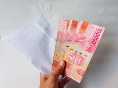 Cash payment concept. Indonesian rupiah currency (Rp. 100.000 Seratus Ribu Rupiah), One hundred thousand Indonesian rupiah money.
