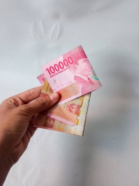 Cash payment concept. Indonesian rupiah currency (Rp. 100.000 Seratus Ribu Rupiah), One hundred thousand Indonesian rupiah money.