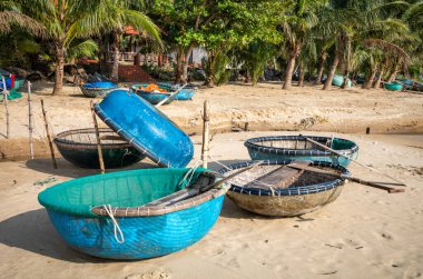 Traditional coracles for fishing pulled up on the undeveloped South Beach (Bi Nam) in  Son Tra, Danang, Vietnam  clipart