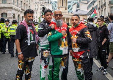 London, UK. 18 May 2024: Four muslim men dressed in colourful pro-Palestinian clothing pose at the Nakba 76 March for Palestine against Israeli attacks on Gaza in central London, UK.  clipart