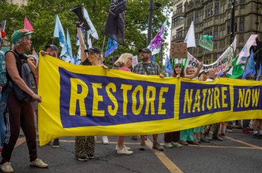 Londra / İngiltere - 22 Haziran 2024: İklim aktivistleri Çevre Koruma için Doğayı Yenileme Yürüyüşü 'nde protesto gösterisi düzenlediler. RSPB, WWF, National Trust, Extinction Rebellion ve diğerleri de dahil olmak üzere 350 grup yürüyüş için birleşti.