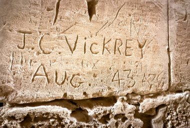 Graffiti carved into a wall at the Roman Amphitheatre at El Jem (Thysdrus) by British soldier JC Vickrey in  August 1943, Tunisia. clipart