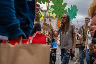 Londra / İngiltere - 22 Haziran 2024: İklim aktivistleri Çevre Koruma için Doğayı Yenileme Yürüyüşü 'nde protesto gösterisi düzenlediler. Yürüyüş için RSPB, WWF, National Trust, Extinction Rebellion ve diğerleri de dahil olmak üzere örgütler.