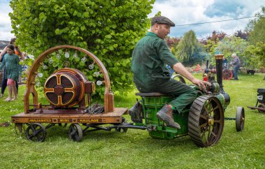 Bir meraklısı, South Downs Steam Railway, Pulborough, West Sussex, İngiltere 'de elektrikli dinamo kullanan minyatür bir traktör kullanıyor..