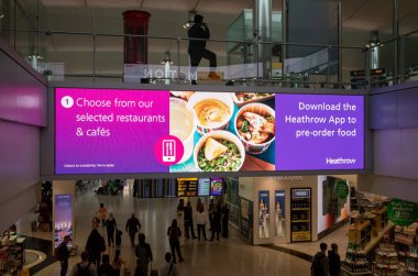 Londra Heathrow Havaalanı, Londra Terminal 2 'deki restoran bilgilerini gösteren aydınlatılmış bir bilgi panosu..