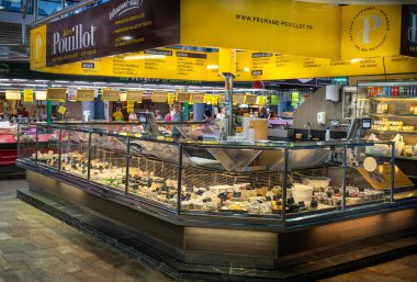 An artesan and traditional cheese stall within the Central Market (Marche des Halles) in Troyes, Aube, France. clipart