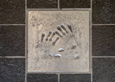 The handprint from famous American filmmaker, artist, and writer Tim Burton set into the pavement of The Alle des toiles (Avenue of the Stars) in Cannes, France.  clipart