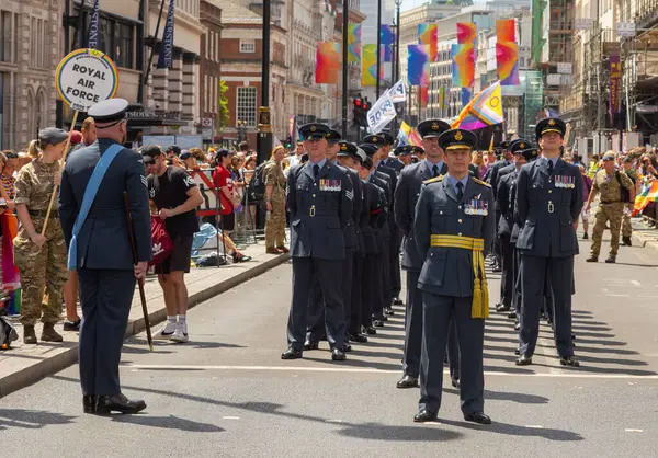 stock image London / UK - Jun 29 2024: A group of Royal Air Force men and women march at the annual Pride in London parade. The celebration brings together people from LGBTQ+ communities.