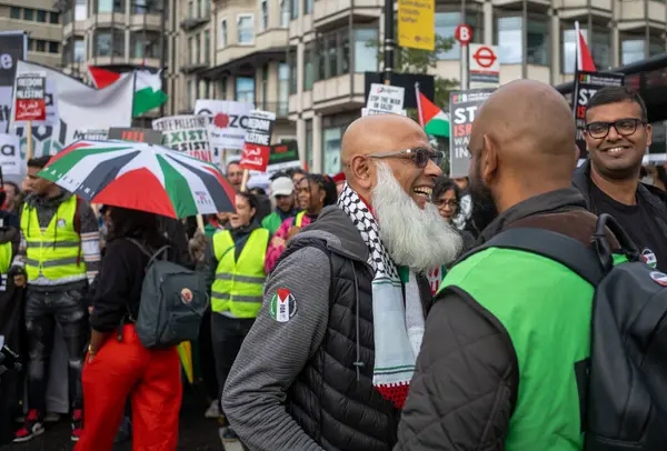 stock image London / UK - Oct 21 2023: Two bearded muslim men greet each other at a mass demonstration of  pro-Palestinian protesters against Israeli attacks on Gaza in central London, UK.