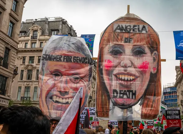 stock image London, UK. 18 May 2024: Protesters hold placards attacking Labour leader Keir Starmer and his deputy Angela Rayner for not supporting a Gaza ceasefire at the Nakba 76 March for Palestine against Israeli attacks on Gaza in central London, UK.