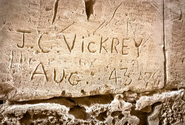 stock image Graffiti carved into a wall at the Roman Amphitheatre at El Jem (Thysdrus) by British soldier JC Vickrey in  August 1943, Tunisia.