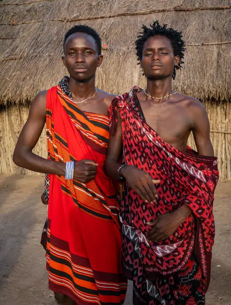 stock image Two male Maasai warrior tribesman wearing shukas in their village Mikumi, Tanzania