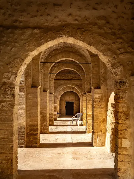 stock image Shadows cut across an arched passageway inside the 8th century religious fortress, the Ribat of Sousse in Tunisia. It is a UNESCO World Heritage Site.