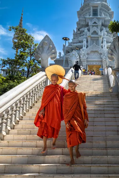 stock image Two buddhist monks descend the stairs from Phnom Preah Reach Troap at Oudong Temple in Kandal Province near Phnom Penh, Cambodia.