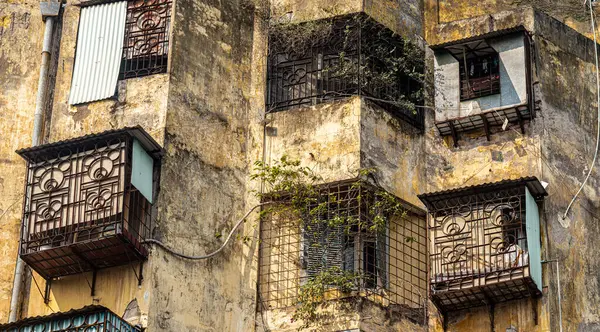 stock image A close up of a delapidated 1960's Soviet-style utilitarian apartment block showing how people extended their space with so-called 