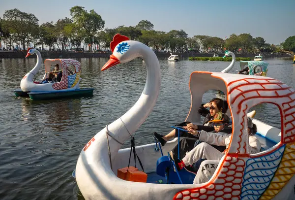 stock image Three children on a swan-shaped pedalo pedal boat on Truc Bach Lake, Hanoi, Vietnam