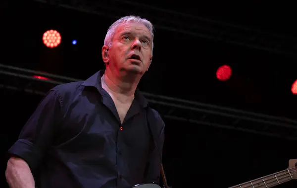 stock image Guildford / UK - Jun 29 2024: Original band member Jean-Jacques Burnel performs with The Stranglers at Guilfest music festival, Guildford, Surrey, UK.