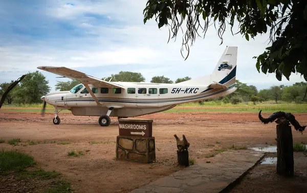 stock image A 12-seat Cessna light plane operated by Auric Air Services departs from Mtemere airstrip at Nyerere National Park (Selous Game Reserve) in Tanzania.