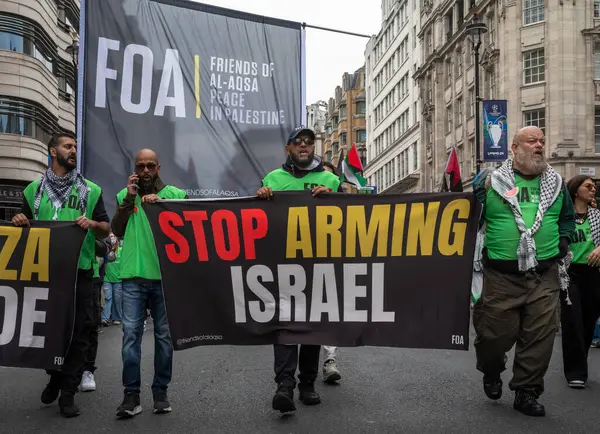 stock image London, UK. 18 May 2024: Activisits from the Friends of Al-Aqsa  hold a banner calling for ending arms sales to Israel at the Nakba 76 March for Palestine against Israeli attacks on Gaza in central London, UK. 