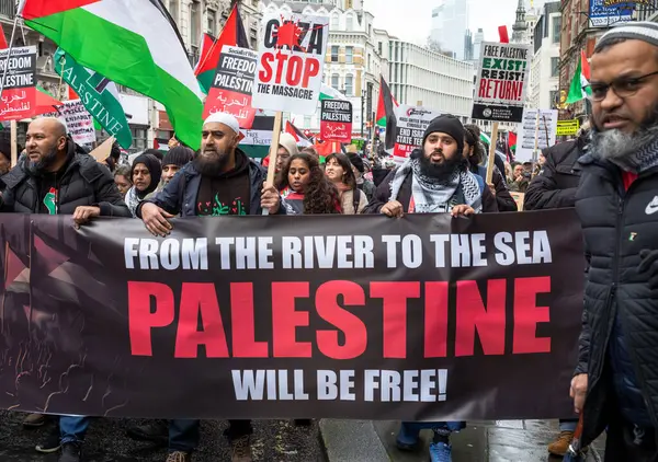 Stock image London, UK. 9 Dec London / UK - Dec 9 2023: Pro-Palestinian muslim protesters hold a banner saying 