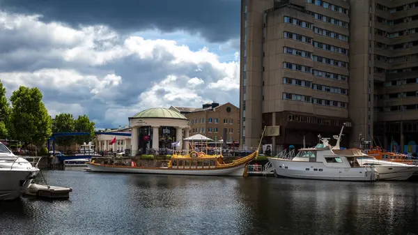 stock image Gloriana, The Queen's Rowbarge, moored in St Katharine Docks near Tower Bridge in London.